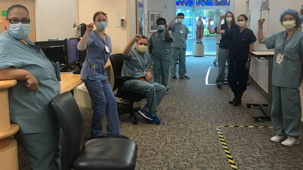 Nurses at Providence Saint John's Health Center in Santa Monica, California, pose shortly after refusing to enter Covid-19 patient rooms on April 9 without being given N95 masks.