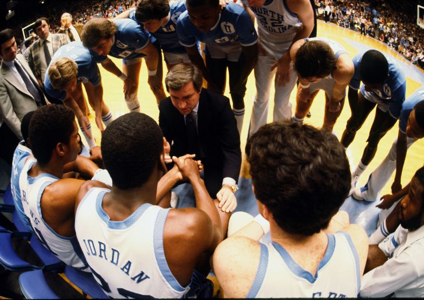 North Carolina players huddle around head coach Dean Smith during a game against Clemson. Jordan was named ACC Freshman of the Year in 1982, but his most memorable contribution came during the NCAA Tournament.