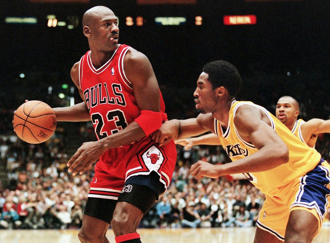 Michael Jordan of the Chicago Bulls (L) eyes the basket as he is guarded by Kobe Bryant of the Los Angeles Lakers.