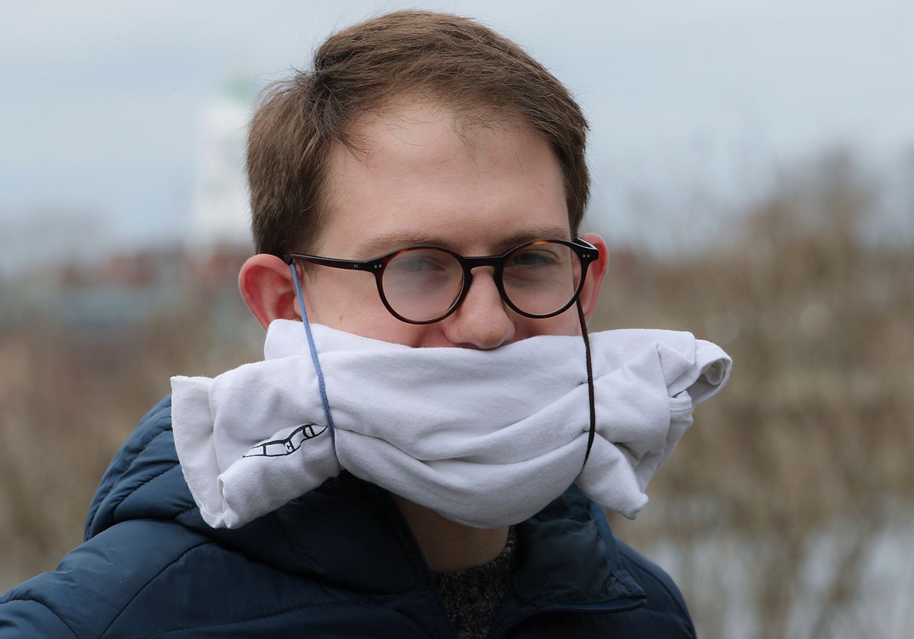 A man wears his girlfriend's rolled-up T-shirt as a mask in Cambridge, Massachusetts.