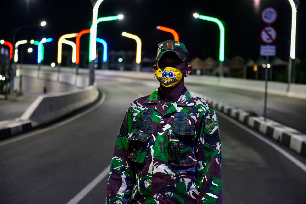 A soldier in Banda Aceh, Indonesia, wears a mask depicting the cartoon character SpongeBob SquarePants.