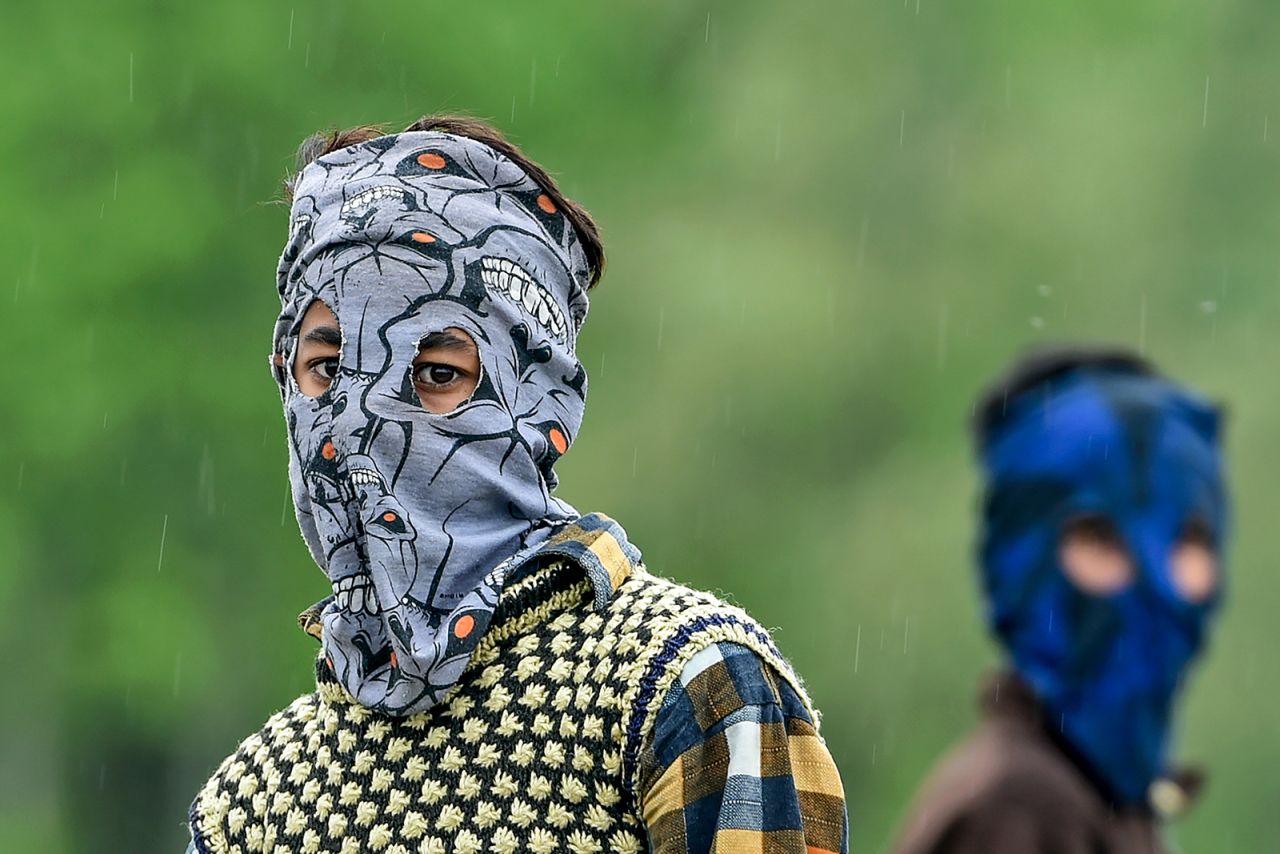 A boy wears a homemade mask while playing cricket in Srinagar, India.