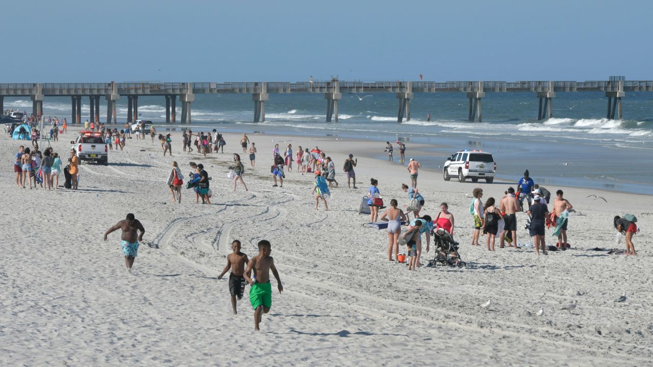 Police vehicles begin to clear Jacksonville Beach after Mayor Lenny Curry ordered all beaches to close at 5 p.m. because of concerns about the spread of the coronavirus on March 20, 2020, in Jacksonville, Florida. 