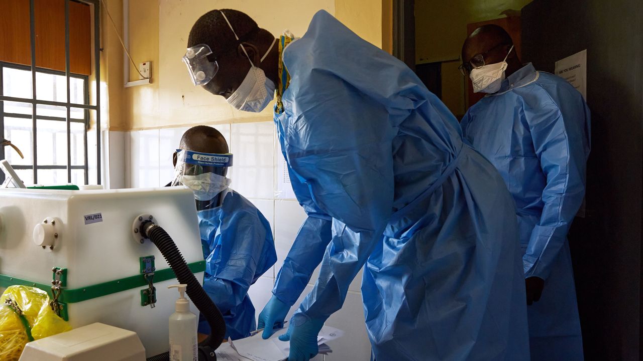 Lab technicians gather around a machine as they test samples for Covid-19 in a laboratory in Juba, South Sudan on April 6.