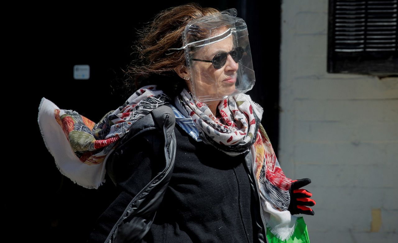 A woman in New York wears a plastic food container for protection.