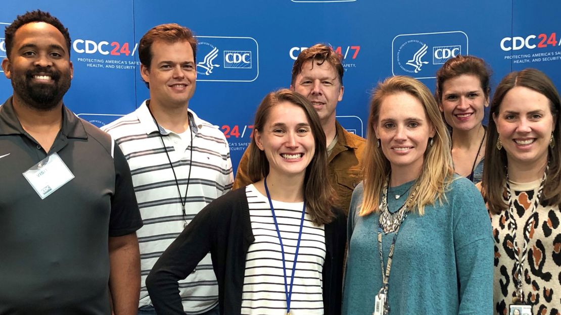 Alissa Eckert, front row in green sweater, and Dan Higgins, back row in white polo shirt, created the coronavirus illustration for the CDC.