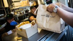 NEW YORK, NY - AUGUST 18:  Customers pick up their orders from Shake Shack on August 18, 2014 in Madison Square Park in New York City. Shake Shack is allegedly considering going public and holding an initial price offering (IPO).  (Photo by Andrew Burton/Getty Images)
