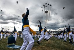 COLORADO SPRINGS, CO - APRIL 18: Spaced eight feet apart, United States Air Force Academy cadets celebrate their graduation as a team of F-16 Air Force Thunderbirds fly over the academy on April 18, 2020 in Colorado Springs, Colorado. After senior cadets spent more than a month on lockdown in the Air Force Academy's dorms due to the coronavirus pandemic, Saturday's graduation, which was moved up by six weeks, marks the first time a military academy is graduating a class early since WWII. (Photo by Michael Ciaglo/Getty Images)