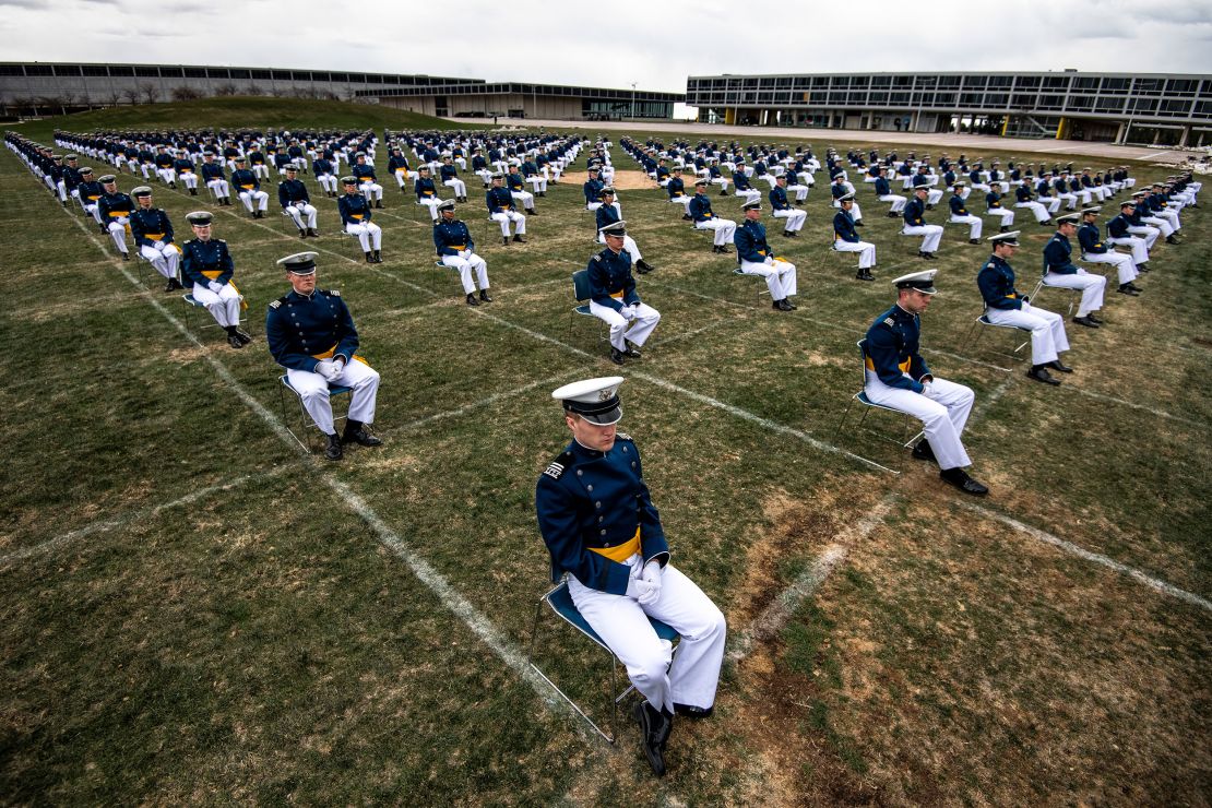 Air Force Academy cadets, spaced 8 feet apart, listen to a commencement address by Vice President Mike Pence Saturday.