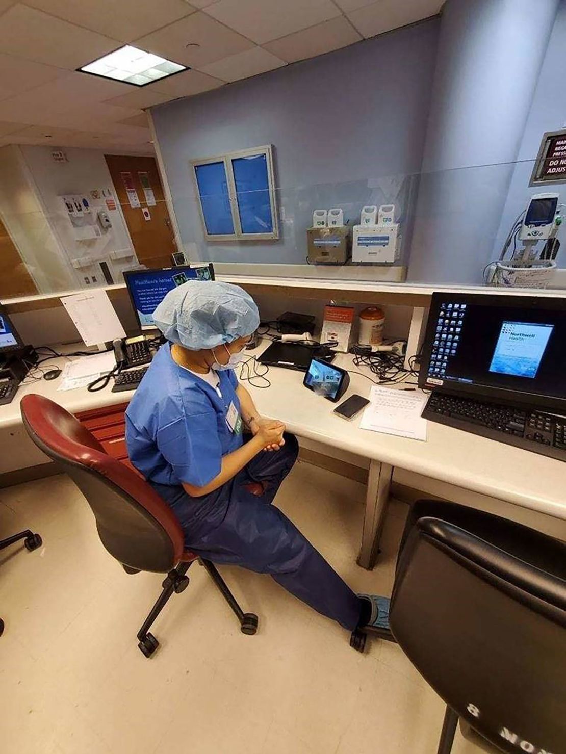 A health care provider at North Shore University Hospital uses an Echo Show to communicate with a coroanvirus patient. 