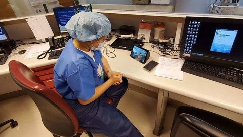 A health care provider at North Shore University Hospital uses an Echo Show to communicate with a coroanvirus patient. 