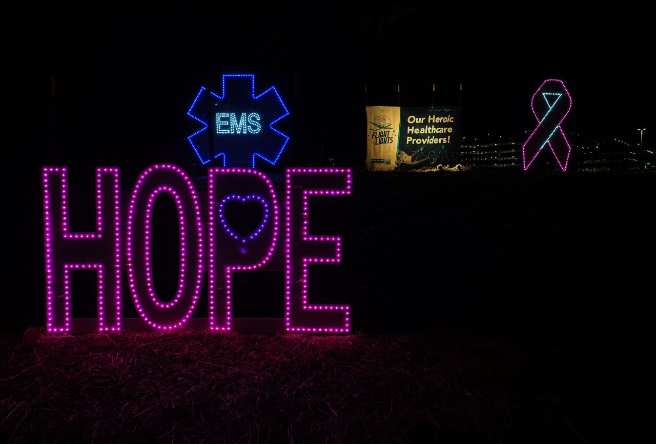 A light display reading "Hope" stands in front of another dedicated to emergency medical services.