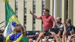 Brazilian President Jair Bolsonaro speaks after joining his supporters who were taking part in a motorcade to protest against quarantine and social distancing measures to combat the new coronavirus outbreak in Brasilia on April 19, 2020. 