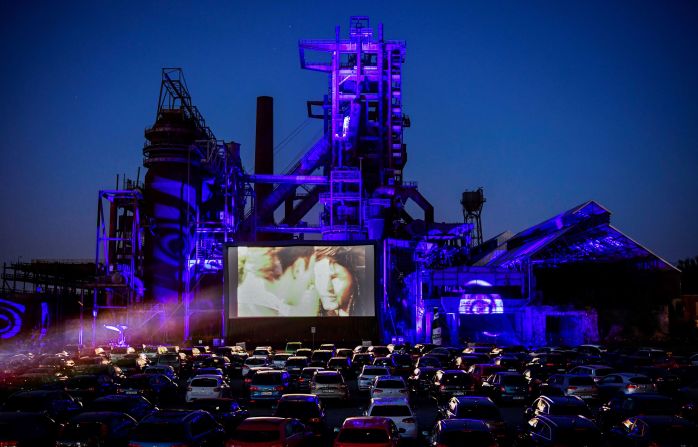 Cars sit at a newly opened drive-in cinema in Dortmund, Germany, on April 17, 2020. It was in front of a former blast furnace.