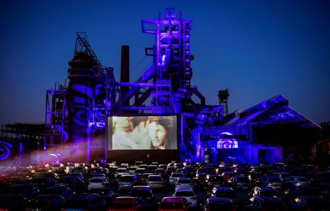 Cars sit at a newly opened drive-in cinema in Dortmund, Germany, on April 17, 2020. It was in front of a former blast furnace.