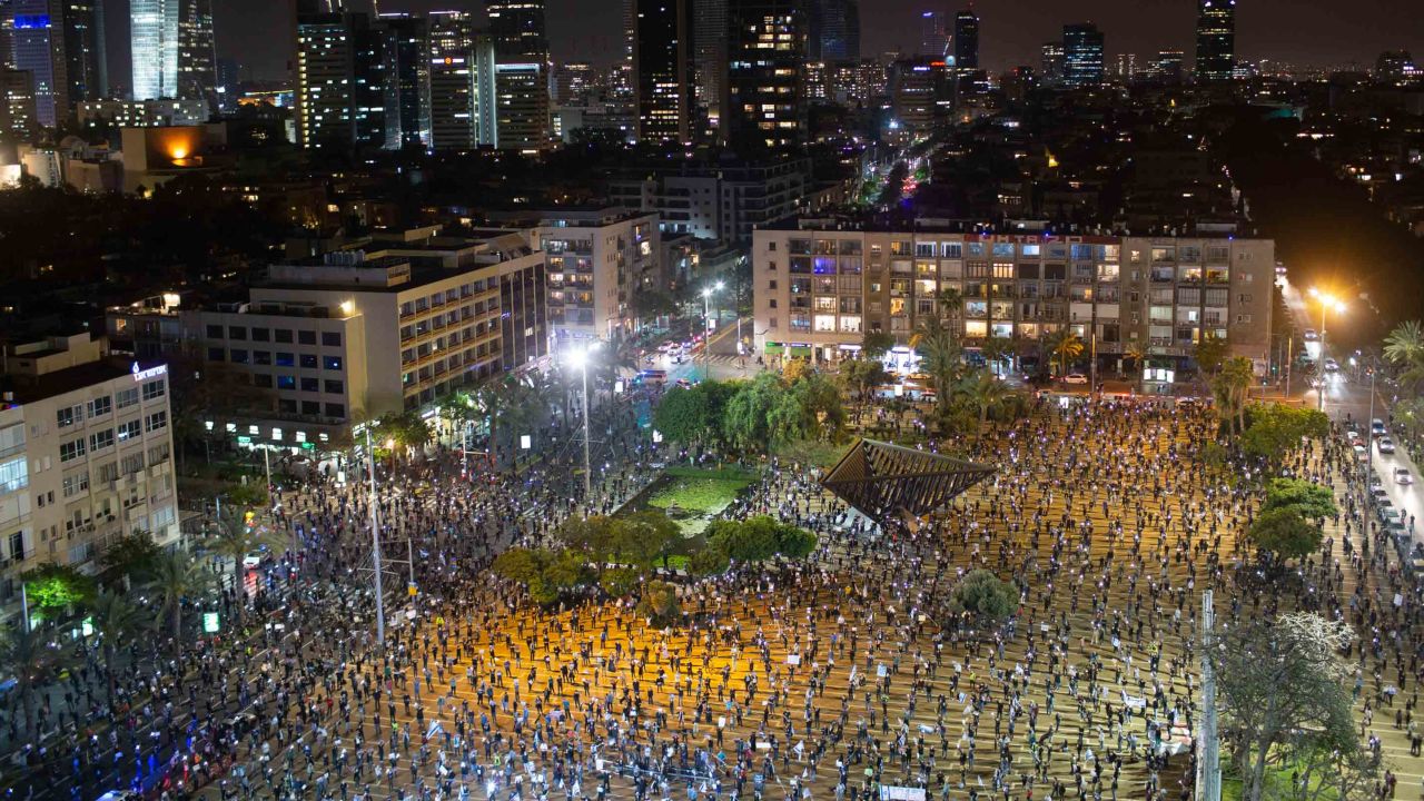 People keep social distancing amid concerns over the country's coronavirus outbreak, during a protest against Prime Minister Benjamin Netanyahu in Tel Aviv, Israel, Sunday, April 19, 2020. More than 2,000 people took to the streets on Sunday, demonstrating against Prime Minister Benjamin Netanyahu's attempts to form an "emergency" government with his chief rival and accusing him of using the coronavirus crisis to escape prosecution on corruption charges. (AP Photo/Oded Balilty)