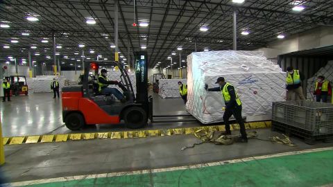 Warehouse workers unload cargo flown in through "Project Airbridge," the administration's effort to expedite the shipment of medical supplies from overseas. 