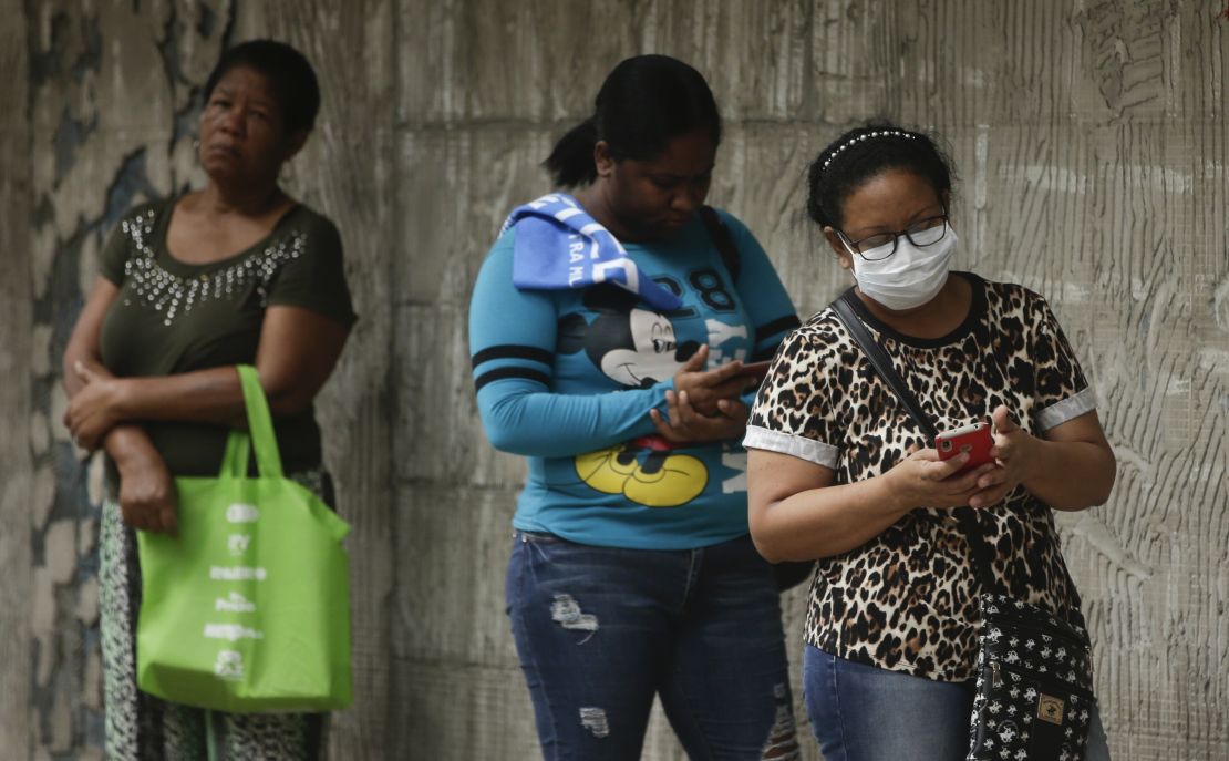 Women wait in line to enter a grocery store, on a day that men must stay indoors in Panama City after the authorities assigned men and women three different days a week on which they can leave home for essential business.