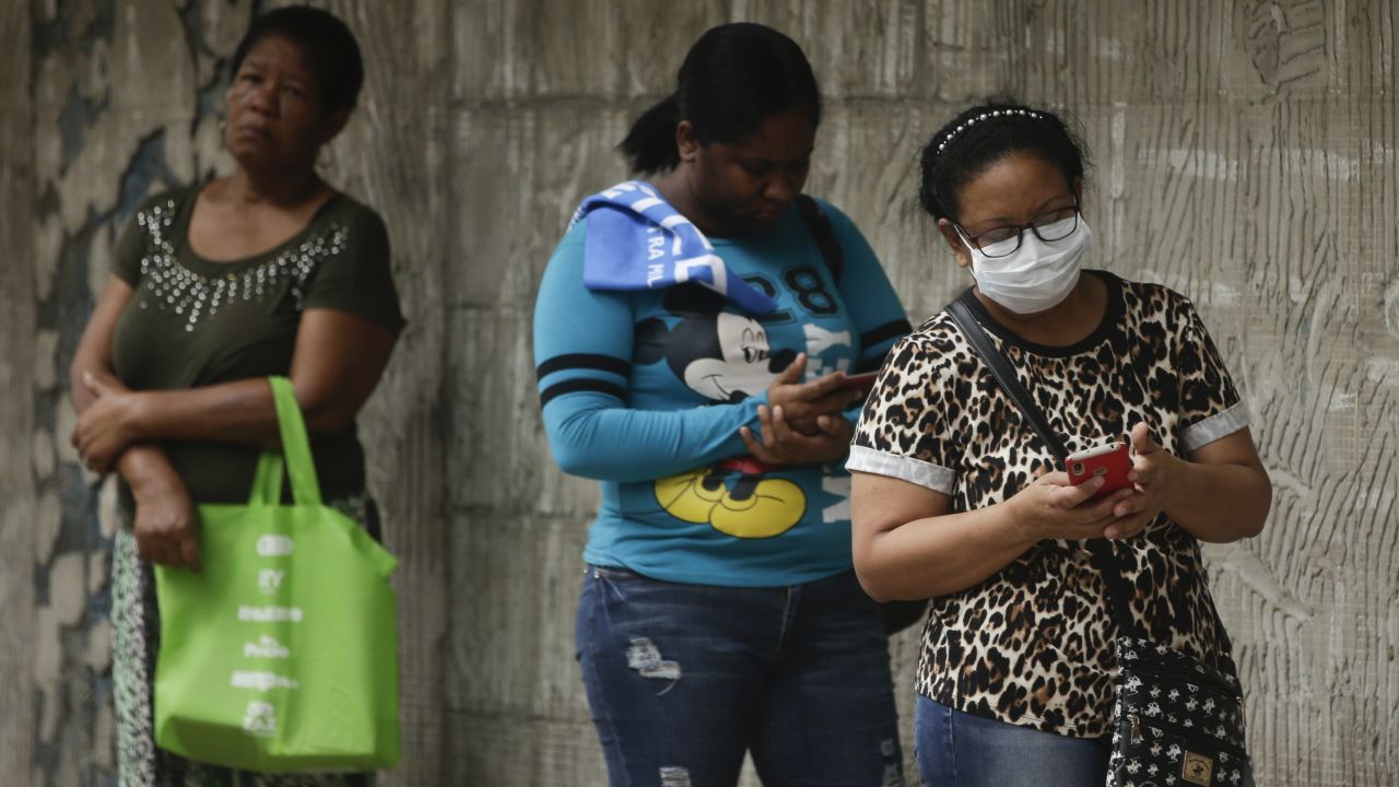 Women wait in line to enter a grocery store, on a day that men must stay indoors in Panama City after the authorities assigned men and women three different days a week on which they can leave home for essential business.