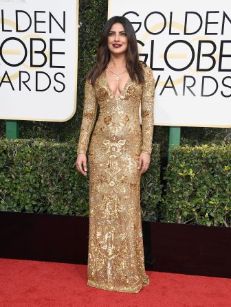 Gold and shimmering at the Golden Globe Awards in 2017. "It's my first time at the Golden Globes, so I wanted to be the golden globe," she told Vogue US.
