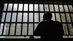 An inmate looks out the window of the Norwich Prison. 