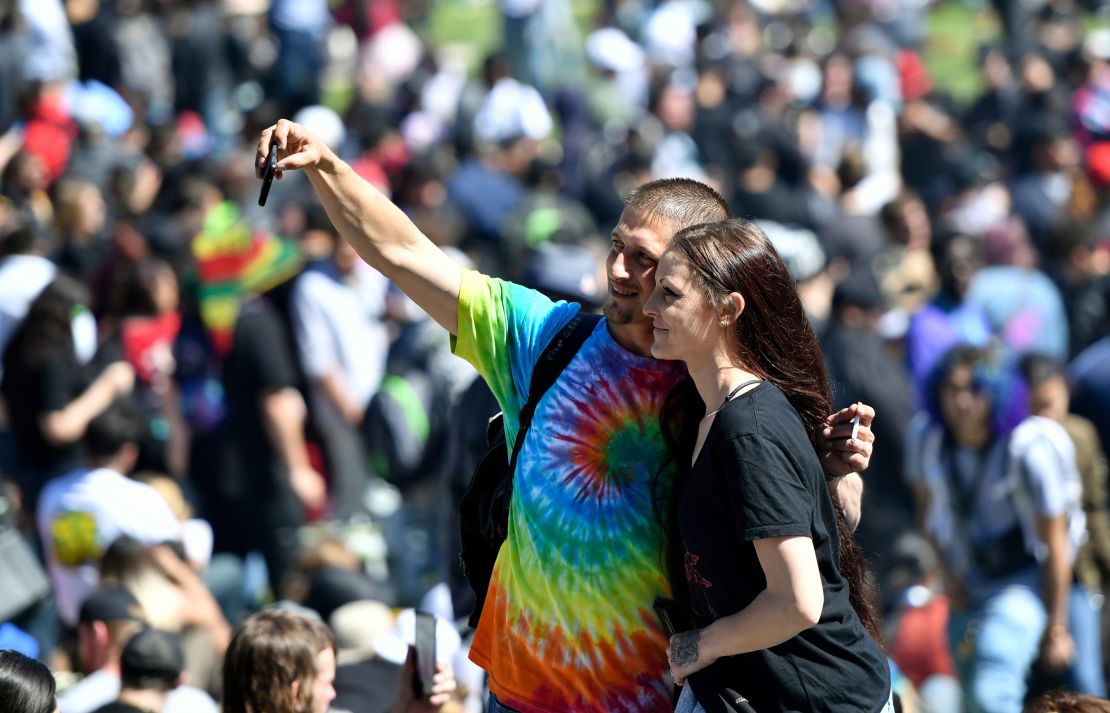 People take a selfie as thousands gather on Hippie Hill in San Francisco, Friday, April 20, 2018. Thousands of people flocked to Hippie Hill for the annual 420 celebration of all things pot and the number that is stoners' code for smoking marijuana. Events also were held in other cities worldwide. (AP Photo/Josh Edelson)