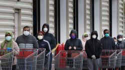 WHEATON, MARYLAND - APRIL 16: Customers wear face masks to prevent the spread of the novel coronavirus as they line up to enter a Costco Wholesale store April 16, 2020 in Wheato