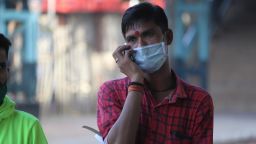 A man talks on a mobile phone while wearing a protective face mask following an outbreak of coronavirus (COVID-19) pandemic on March 21, 2020 in Mumbai, India. (Photo by Himanshu Bhatt/NurPhoto via Getty Images)