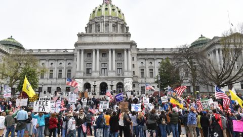 People take part in a "reopen" Pennsylvania demonstration on April 20, 2020 in Harrisburg, Pennsylvania. - Hundreds have protested in cities across America against coronavirus-related lockdowns -- with encouragement from President Donald Trump -- as resentment grows against the crippling economic cost of confinement.