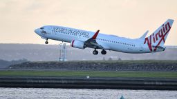 A Virgin Australia flight takes off from Sydney International Airport in Sydney on March 27, 2020.