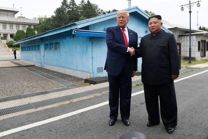 Trump and Kim shake hands as the two <a href="index.php?page=&url=https%3A%2F%2Fwww.cnn.com%2F2019%2F06%2F30%2Fworld%2Fgallery%2Ftrump-kim-north-korea%2Findex.html" target="_blank">meet at the Korean Demilitarized Zone</a> in June 2019. Trump briefly stepped over into North Korean territory, becoming the first sitting US leader to set foot in the nation. Trump said he invited Kim to the White House, and both leaders agreed to restart talks after nuclear negotiations stalled. 