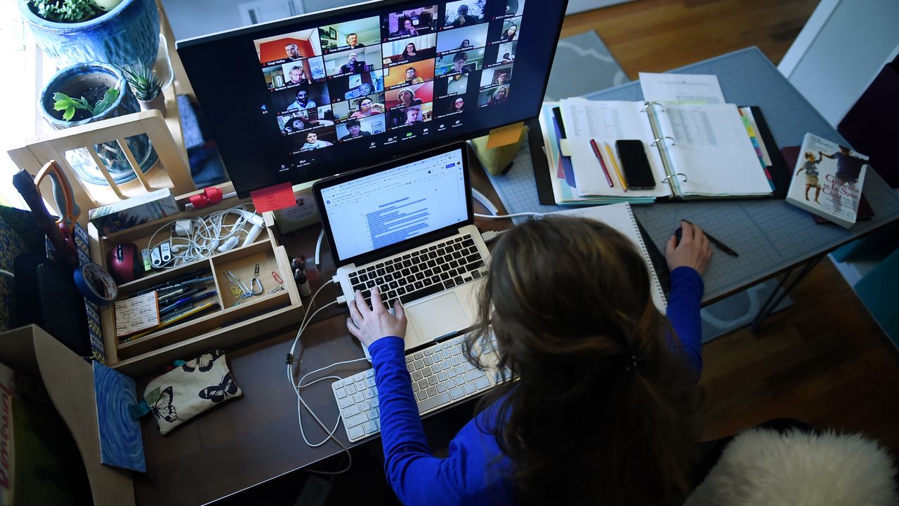 A lower school substitute teacher works from her home due to the Coronavirus outbreak on April 1, 2020 in Arlington, Virginia. - Her role in the school changed significantly when Coronavirus hit. She was previously working part time to support teachers when they needed to be absent from the classroom and now she helps them to build skills with new digital platforms so they can continue to teach in the best way for their students and their families.The middle school (grades 6-8) has most regularly been using Zoom and the lower grades have been using Zoom with parents. (Photo by Olivier Douliery/AFP/Getty Images)