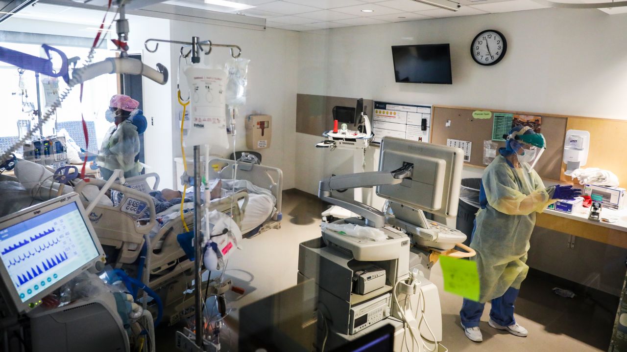 Nurses wear full PPE while caring for an intubated COVID-19 patient on the MICU floor at Boston Medical Center in Boston on April 15, 2020.