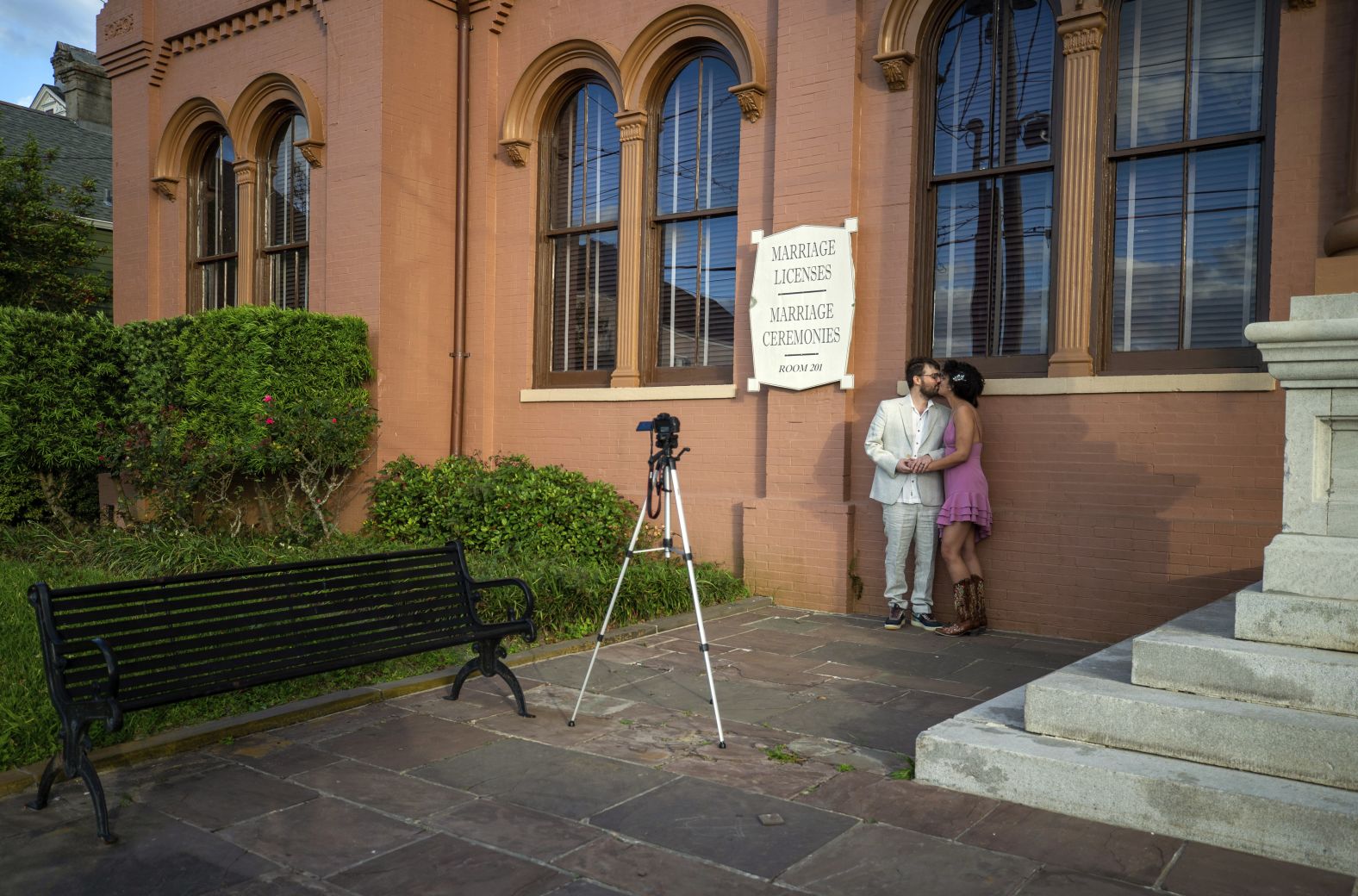 Patrick Crilly and Deja Trudeaux, at a distance from their friends and family, kiss after taking their own engagement photograph in front of the Algiers Courthouse in New Orleans on March 31.