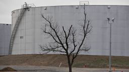A tree stands near oil storage tanks at the Enbridge Inc. Cushing storage terminal in Cushing, Oklahoma, U.S., on Wednesday, March 25, 2015. The fastest oil-inventory growth on record at the main U.S. hub may be about to end, easing concern that storage limits will be strained. Photographer: Daniel Acker/Bloomberg via Getty Images