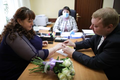 Newlyweds exchange rings during their marriage registration at the Tagansky registry office in Moscow on April 10.