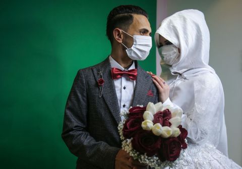 Mohamed Abu Daga and his bride, Israa, pose for photos before their wedding ceremony in Khan Yunis, Gaza, on March 23.