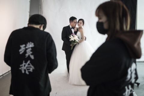 A couple poses for photos at the Pushi wedding photography studio in Wuhan, China, on April 15.