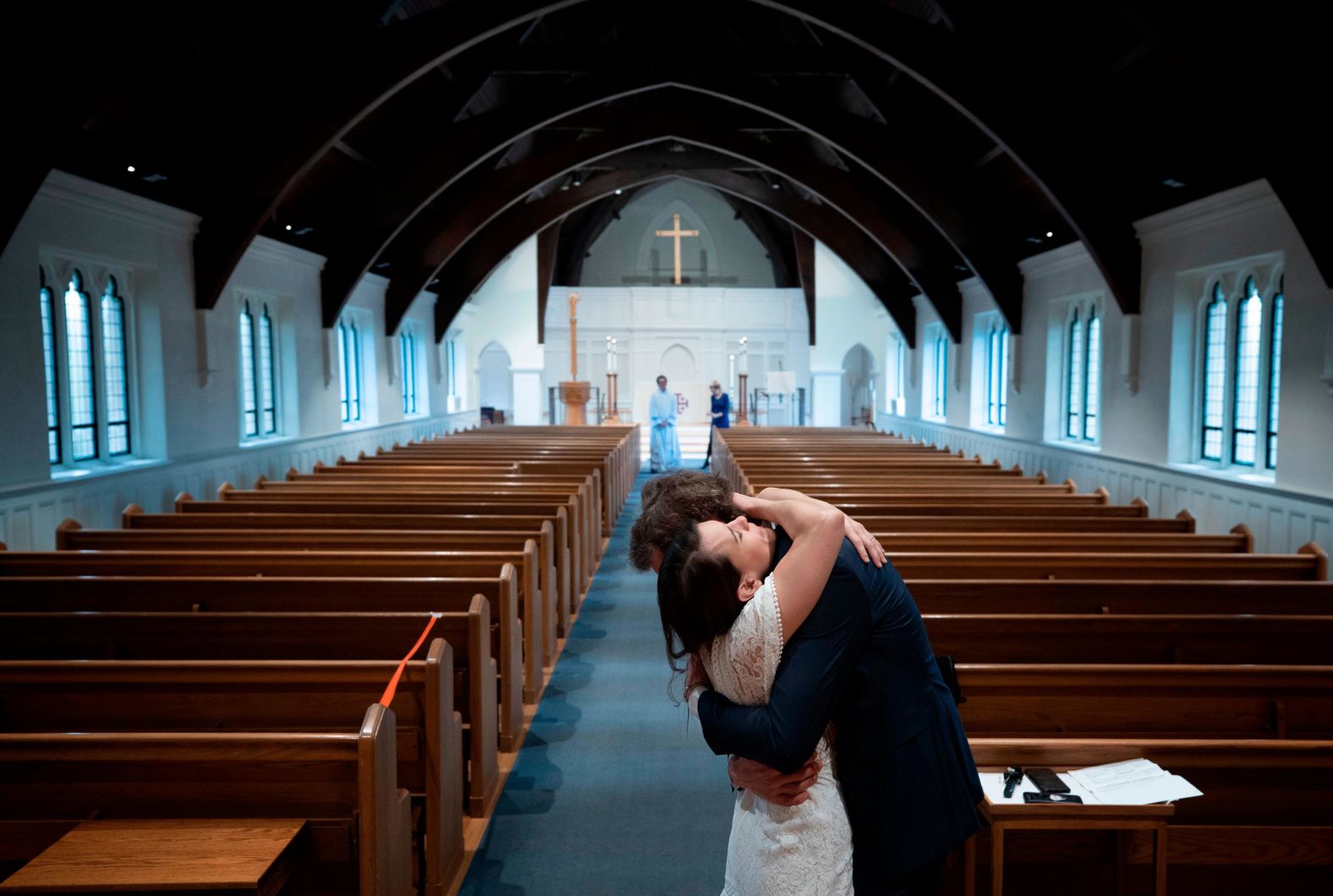 Newly married Tyler and Caryn Suiters embrace following a marriage ceremony performed by the Rev. Andrew Merrow at the St. Mary's Episcopal Church in Arlington, Virginia, on April 18. Merrow and his wife, Cameron, were the only other attendees at the ceremony due to social-distancing guidelines.