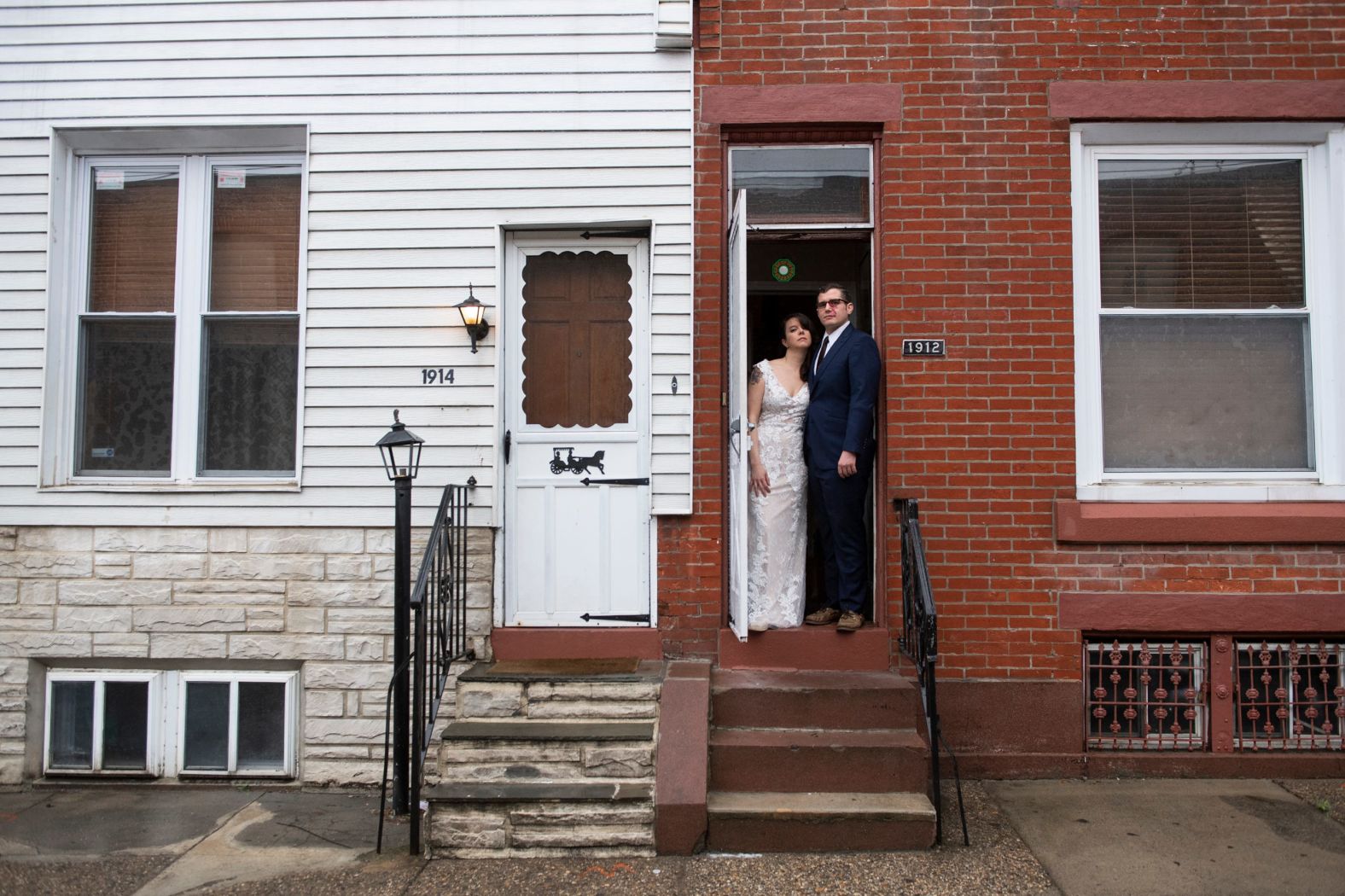 Amelia Ward and Brandon Wright pose in their wedding dress and suit at their home in Philadelphia on March 28. Their wedding was supposed to be the day before in New Orleans, but it was postponed due to the Covid-19 pandemic. They pushed their wedding back a year.