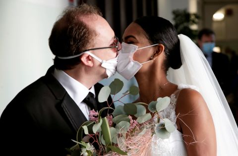 Diego Fernandes and Deni Salgado kiss through face masks at a wedding ceremony in Naples, Italy, on March 20. There were no guests, only witnesses.