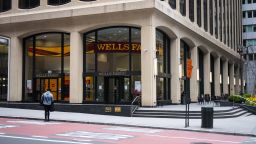A pedestrian crosses an empty street in front a temporarily closed Wells Fargo & Co. Bank branch in New York, U.S., on Friday, April 10, 2020. Wells Fargo is scheduled to release earnings figures on April 14. Photographer: Mark Kauzlarich/Bloomberg via Getty Images