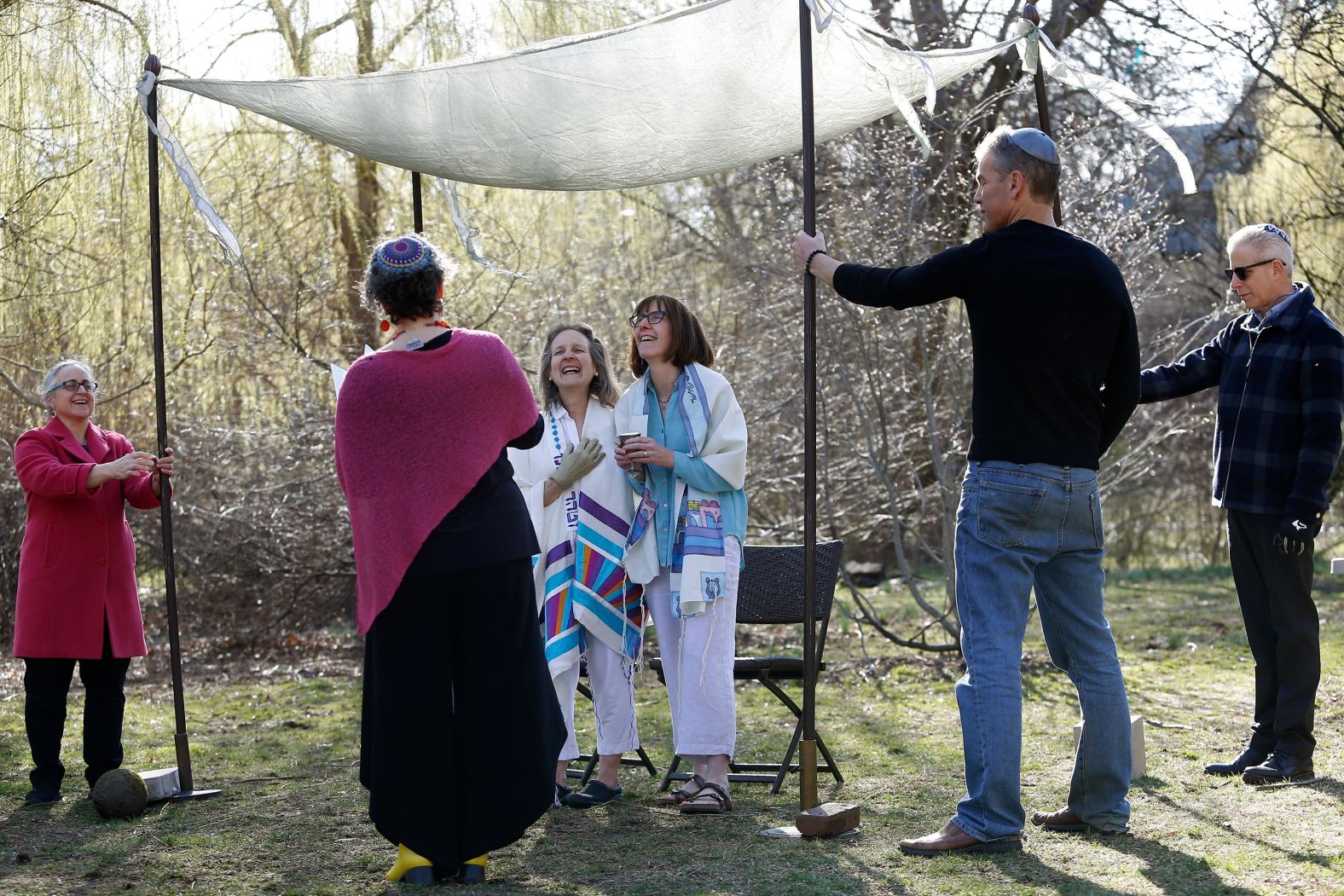 Rabbi Claudia Kreiman marries Elisheva Dan and Mara Mooiweer during their wedding at Griggs Park in Brookline, Massachusetts on March 26. The couple were eager to be married as soon as possible after one of them had been diagnosed with cancer. They held a socially distanced ceremony.