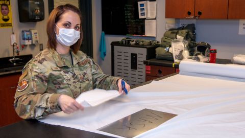 An aircrew flight equipment specialist with the 140th Wing, Colorado National Guard assists with making facemasks. 