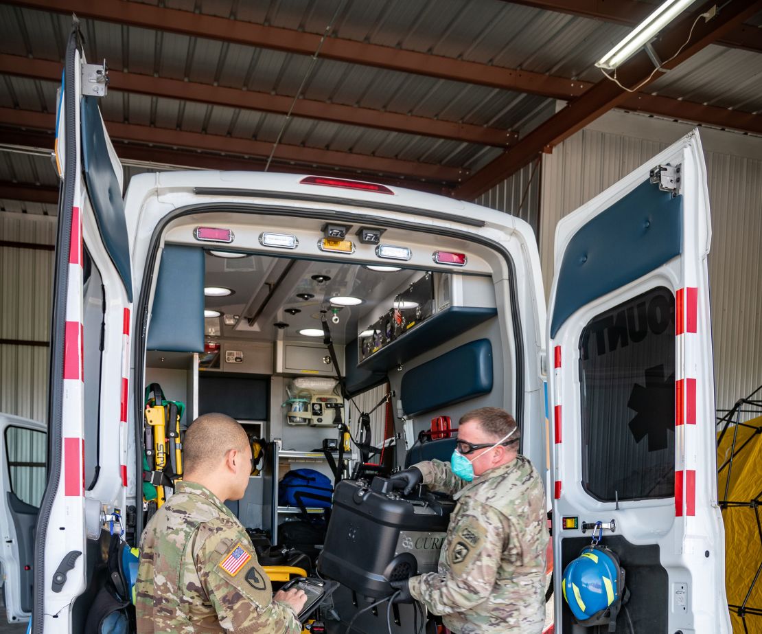 Members of the West Virginia National Guard perform COVID-19 decontamination of first responder vehicles.