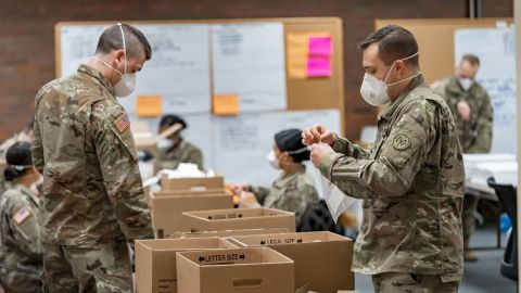 New York Army National Guard members assemble novel coronavirus  specimen collection test kits at the New York State Department of Health's Wadsworth Center in Albany.
