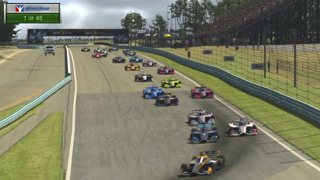 In this image taken from video provided by iRacing IndyCar, Pato O'Ward, foreground, heads into a turn during the opening lap of the American Red Cross Grand Prix virtual IndyCar auto race at Watkins Glen International. 