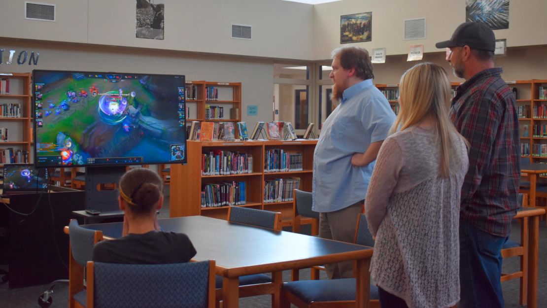 Students, parents and Clinton High School staff gather in the library to watch the March 4 League of Legends match by the Clinton Cougars esports team. 
