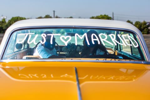 Philip Hernandez and Marcela Peru pose for a picture in the Honda Center parking lot after they were married by a county clerk in Anaheim, California, on April 21.