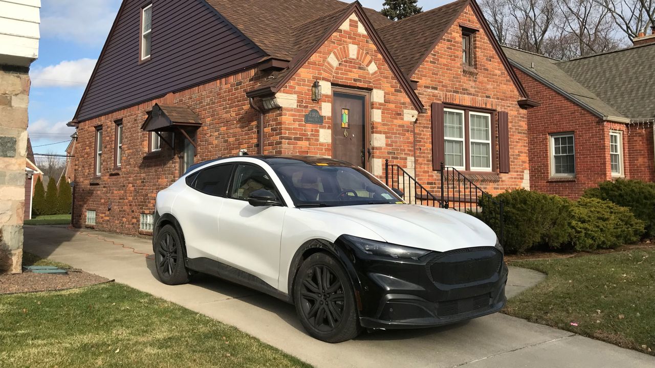 A Ford Mustang Mach-E test vehicle parked in an engineer's driveway.